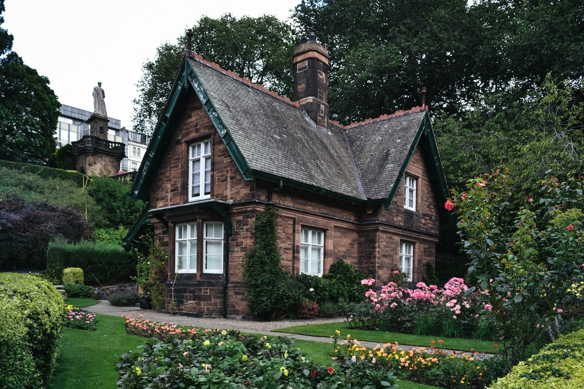Stone cottage surrounded by a flower garden