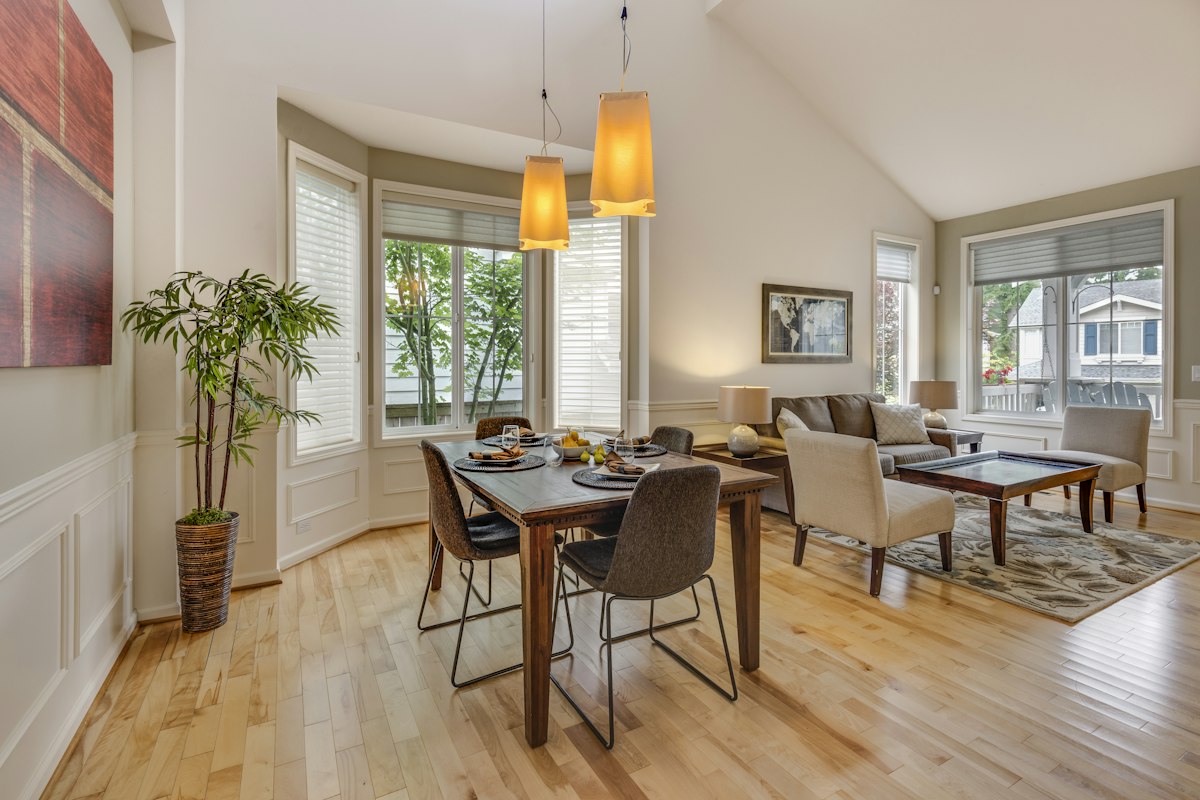 Sunlit dining room with a wooden table