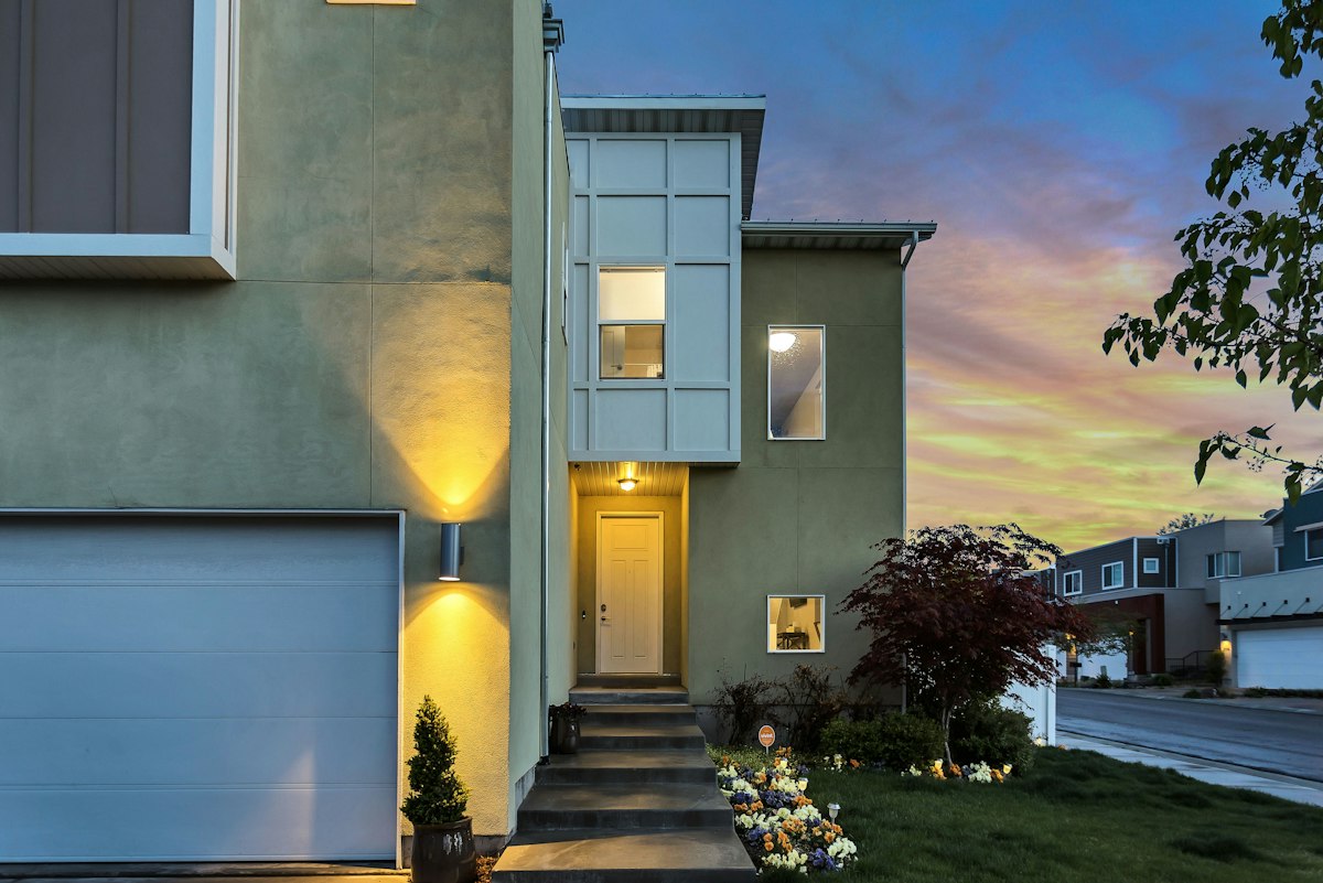 Contemporary home at dusk with lit windows